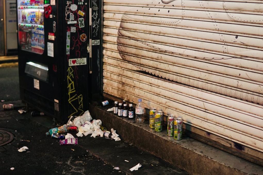 Aluminium cans, bottles, and other trash stashed next to a vending machine in Shibuya. Photo: Shutterstock