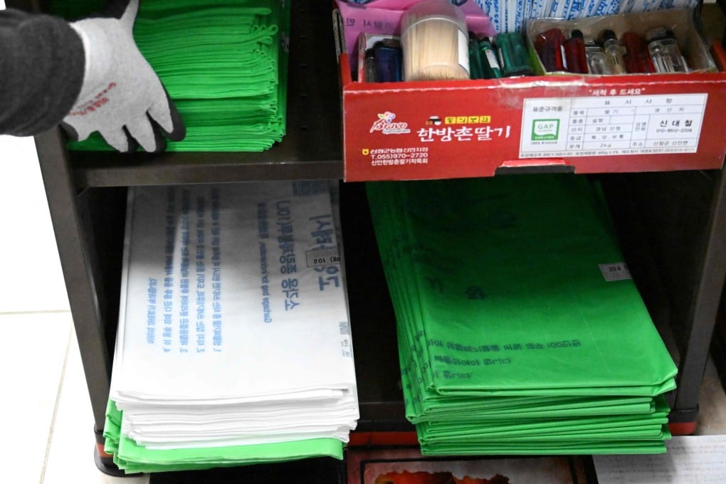 A cashier checks government-regulated bin bags at a checkout in Goyang, South Korea, on Monday. South Korea’s energy minister has sought to ease fears over shortages of plastic rubbish bags. Photo: AFP