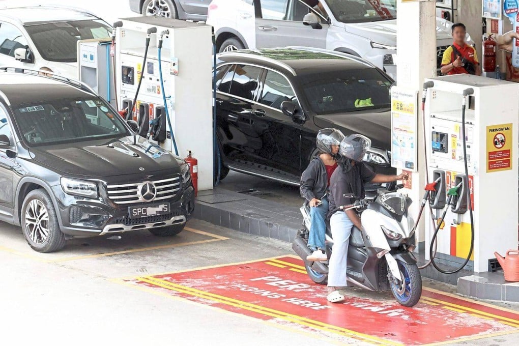 Singapore-registered cars filling up with RON97 at a petrol station in Johor Bahru, Malaysia. Photo: The Star