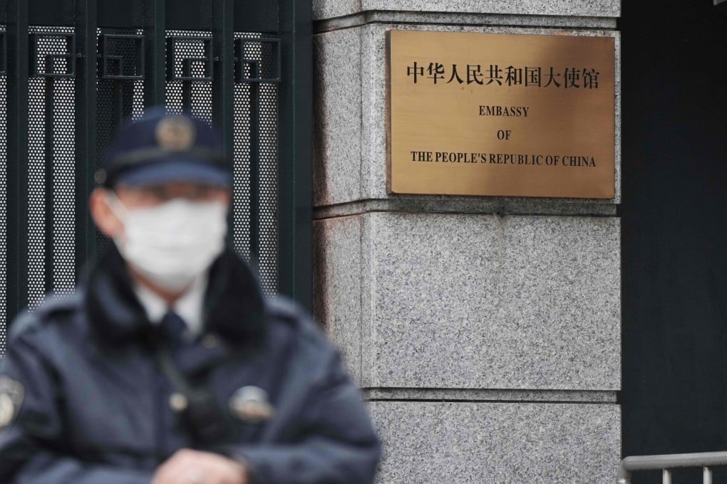 A policeman stands guard at an entrance to the Chinese embassy in Tokyo on March 25. Photo: AFP