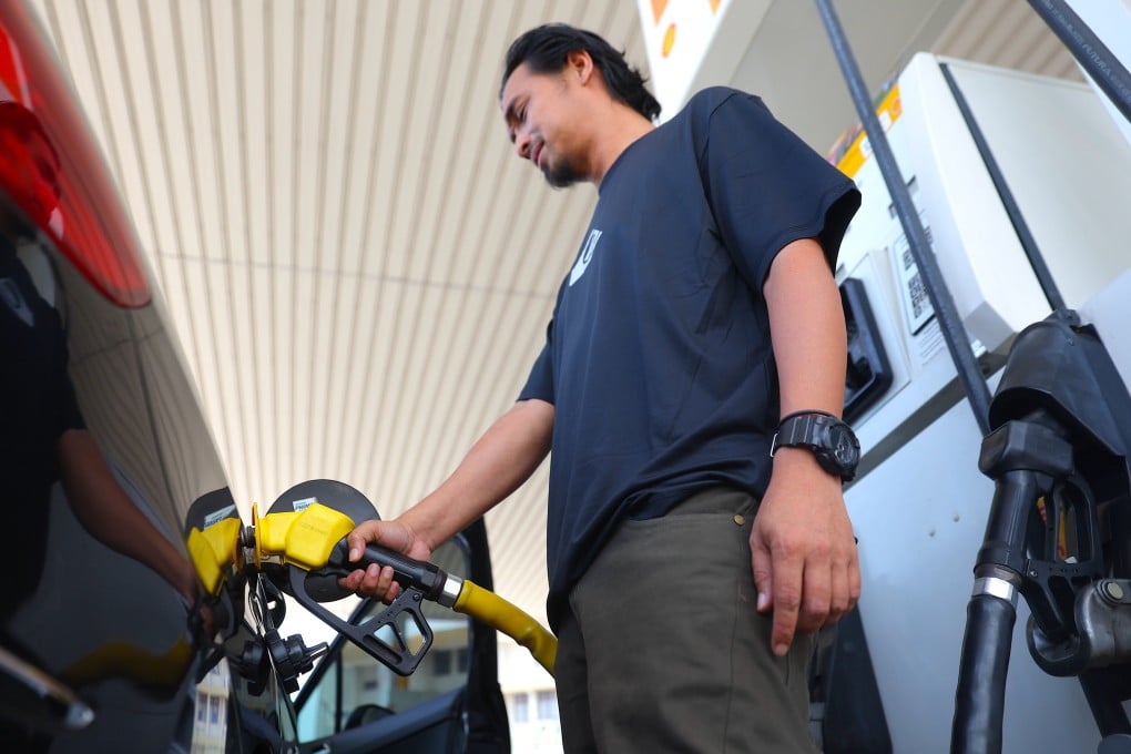 A man fills his car with petrol in Port Dickson, Negeri Sembilan, Malaysia. Photo: EPA