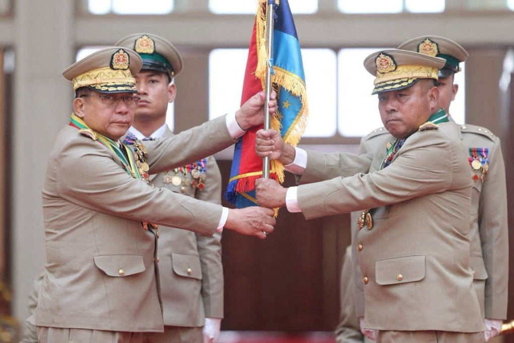 Myanmar junta chief Senior General Min Aung Hlaing hands over a flag to newly appointed Commander-in-Chief General Ye Win Oo at a ceremony in Naypyitaw on Monday. Photo: Handout via Reuters