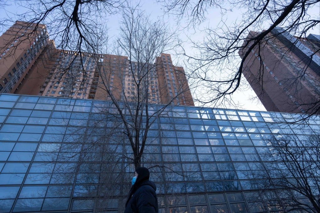 A woman walks past a China Vanke residential complex in Beijing’s Changping district in December. Photo: AP