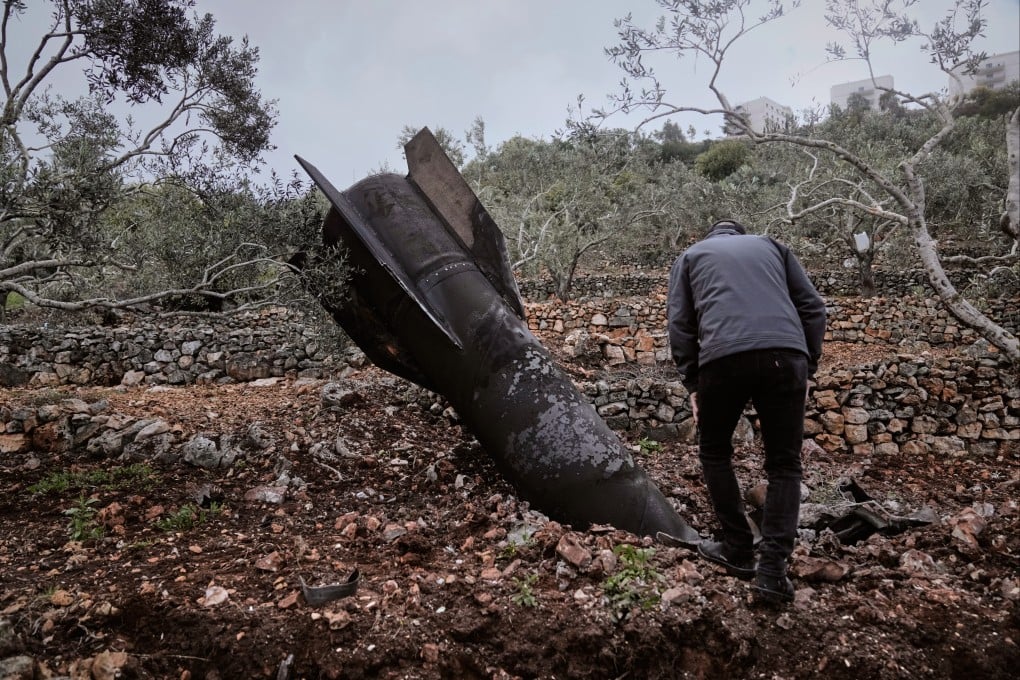 A man inspect the wreckage of an Iranian missile that landed near the West Bank village of Marda on Tuesday. Photo: AP