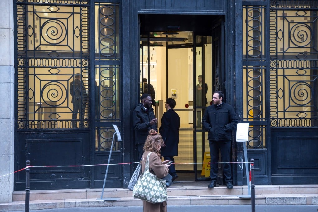People stand outside the Bank of America headquarters in Paris on Wednesday. Photo: EPA