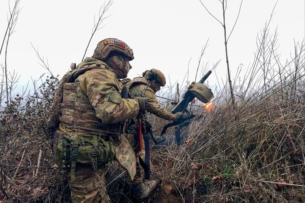 Russian soldiers fire a grenade launcher towards Ukrainian positions in an image released on Tuesday. Photo: Russian Defence Ministry Press Service via AP