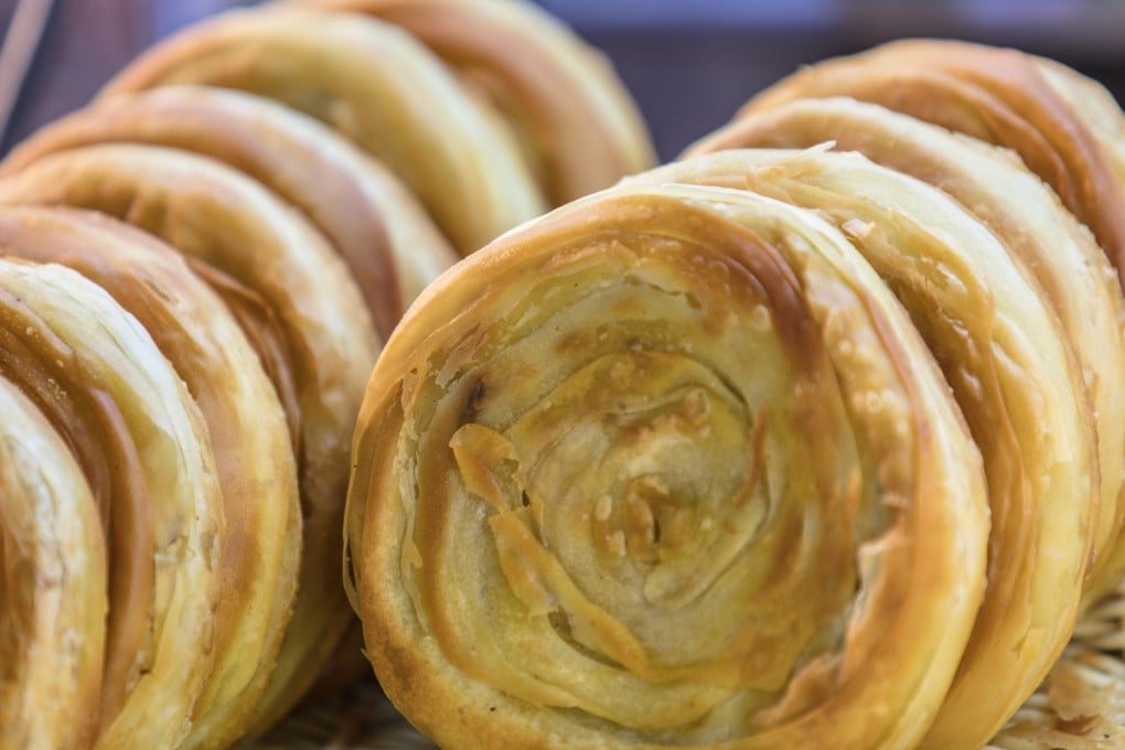 Today, the descendants of “hubing” Chinese flatbreads survive in everyday foods like “shaobing” (pictured), the ubiquitous flatbread sold at neighbourhood food stalls, and “nang”, the naan-like Xinjiang flatbreads still baked by pressing the dough against the walls of clay ovens. Photo: Shutterstock