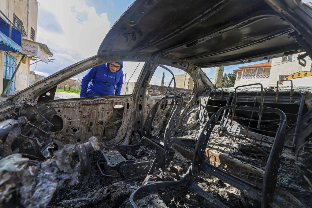 A Palestinian boy looks at a burnt vehicle following a reported attack by Israeli settlers in Jalud village, south of Nablus in the occupied West Bank. Photo: AFP