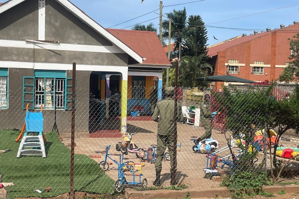 Uganda police officers stand at the crime scene after a man killed four children in an attack at the Gaba Early Childhood Development Program nursery school in Kampala, Uganda on Thursday. Photo: AP