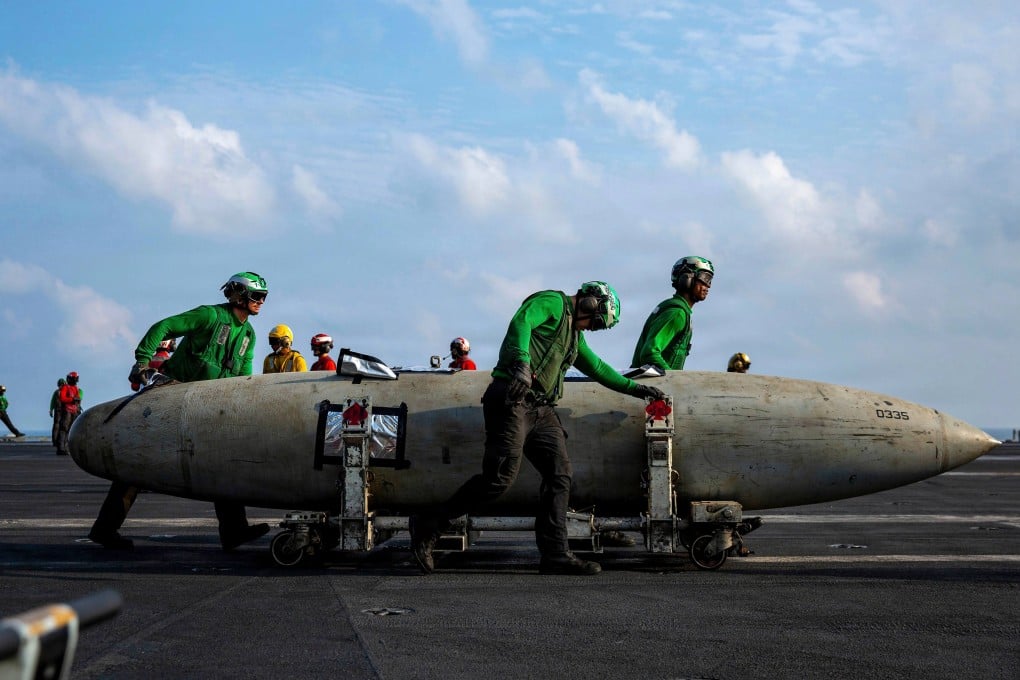 US Navy sailors move a F/A-18 fighter aircraft fuel tank on the flight deck of the Nimitz-class aircraft carrier USS Abraham Lincoln during Operation Epic Fury late last month. Photo: US Navy/dpa