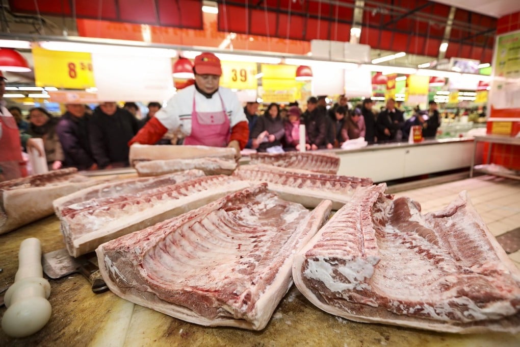 A supermarket employee cuts pork in Huaian city, Jiangsu province. Photo: Costfoto/Future Publishing via Getty Images