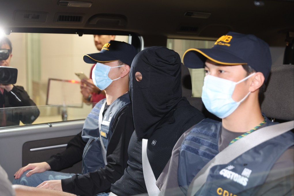 A suspect is escorted by Hong Kong customs officers at the department’s headquarters in North Point. Photo: Edmond So