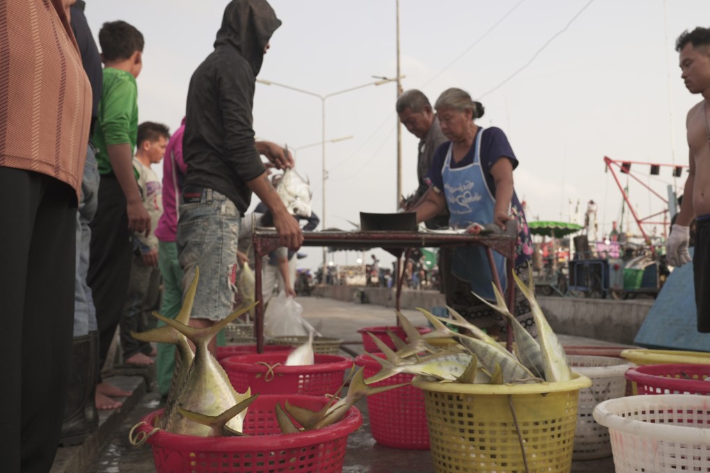 Fishermen at a pier in Chonburi, Thailand. Photo: Aidan Jones
