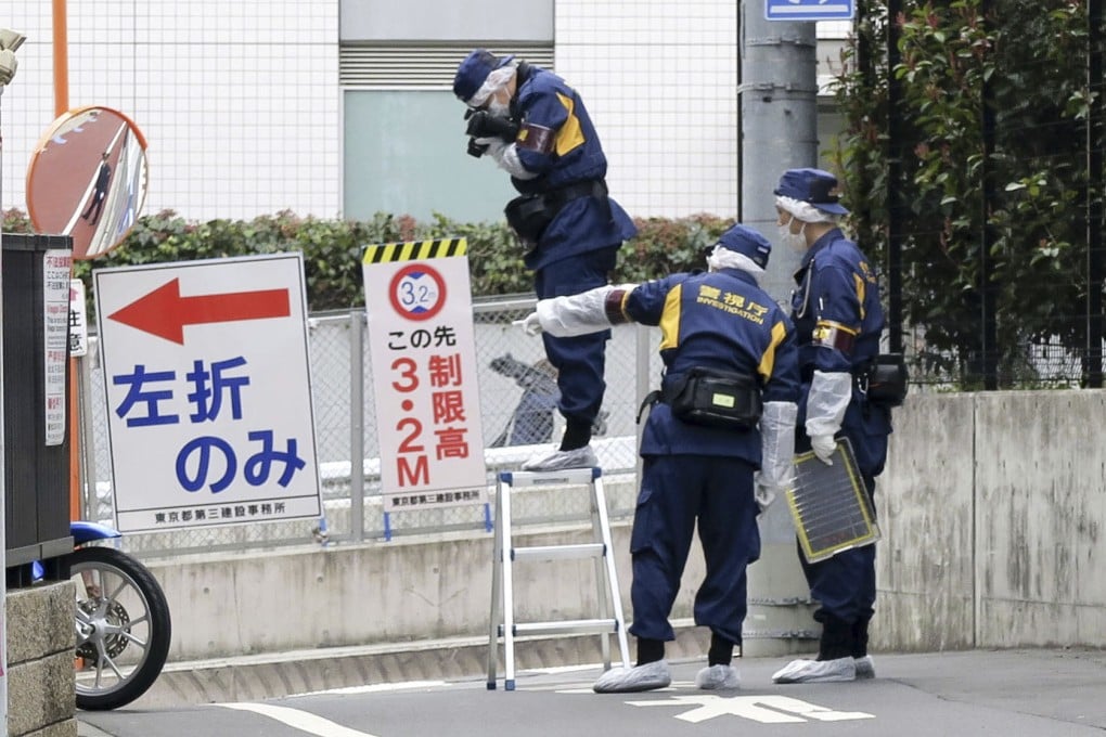 Japanese police investigators work near the scene of a stabbing of a woman in the Shinjuku district of Tokyo on March 11. Photo: Kyodo/AP