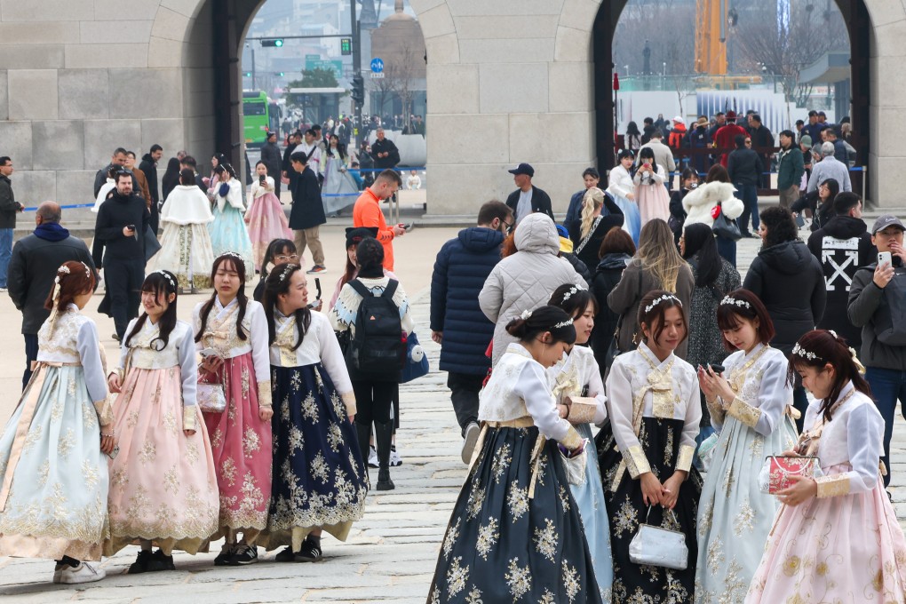 Tourists walk around Gyeongbok Palace in central Seoul, South Korea, on March 15. Photo: EPA
