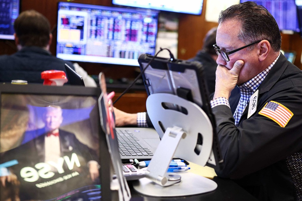 A trader works on the floor of the New York Stock Exchange at the opening bell in New York on Thursday. Wall Street stocks tumbled early Thursday on the latest jump in oil prices as tough rhetoric between the United States and Iran reduced hopes of a Middle East war resolution. Photo: AFP