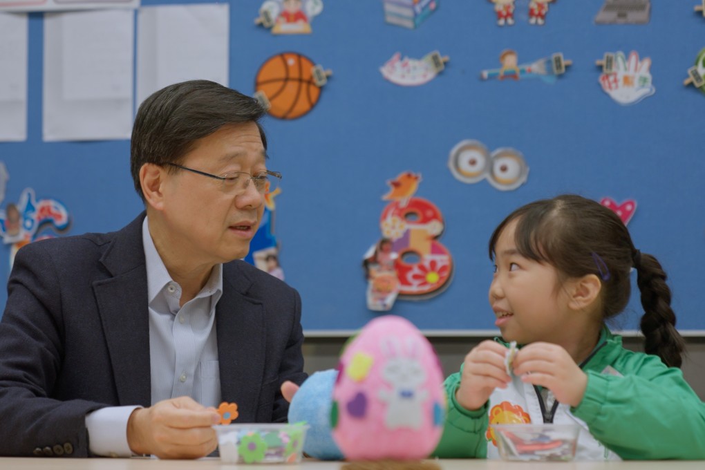 Chief Executive John Lee speaks to a pupil during a school visit. Photo: Handout