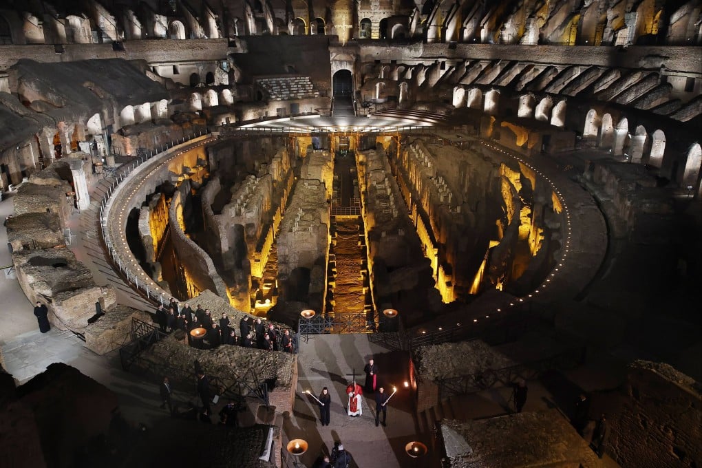 Pope Leo holds a wooden cross as he leads the Via Crucis procession at the Coliseum in Rome on Good Friday. Photo: dpa