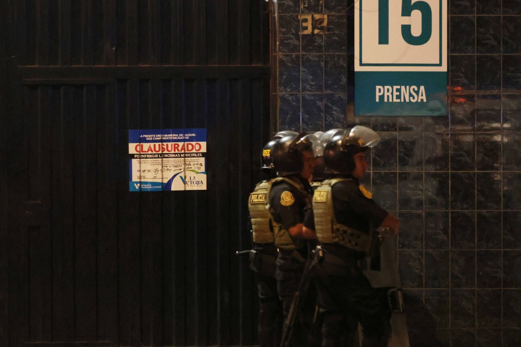 A closed poster is seen at the entrance of the Alejandro Villanueva Stadium in Peru, while police officers stand guard after a fatal accident. Photo: AFP