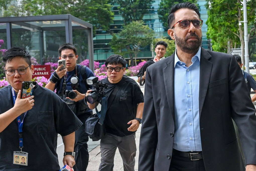 Worker’s Party chief Pritam Singh (centre) is followed by journalists as he leaves the Supreme Court during an appeals hearing on November 4, 2025. Photo: AFP