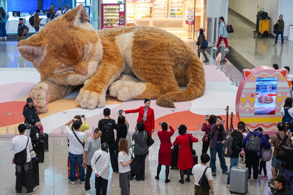 ‘A Moment to Purr’, a giant interactive cat art installation, is located at the arrivals hall of Terminal 1 at Hong Kong International Airport. Photo: Eugene Lee