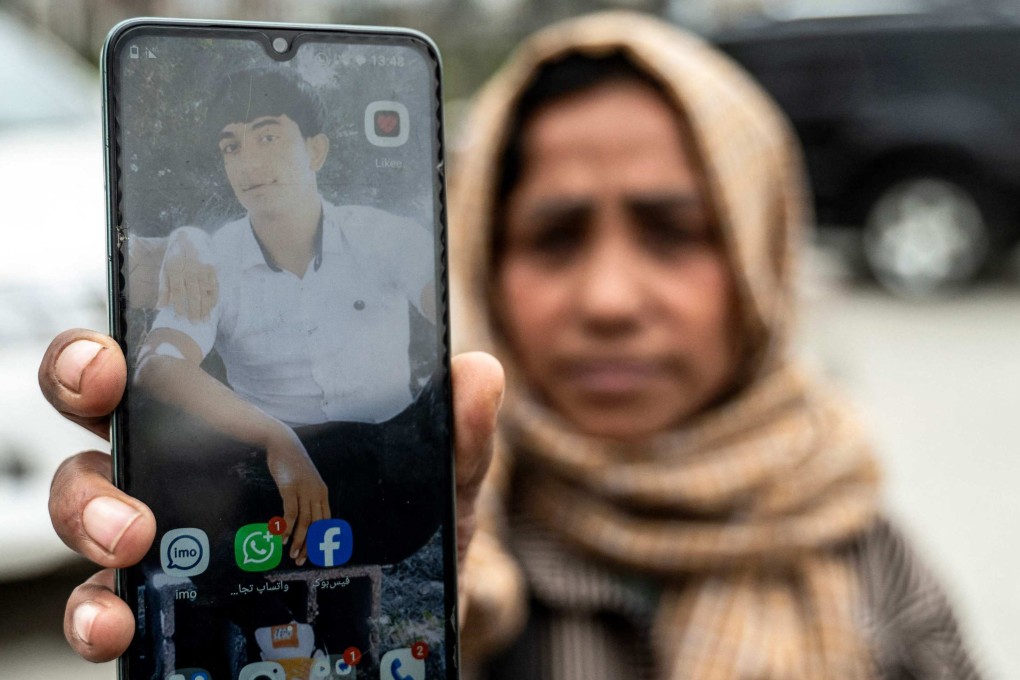 Samira Muhammadi holds up a photograph of her son, Aref Khan, who was killed by a Pakistani airstrike that struck a drug rehabilitation centre on March 16.Photo: AFP