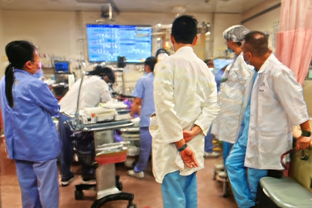 The photo shows Jensen So performing the procedure while surrounded by hospital staff. Photo: Handout