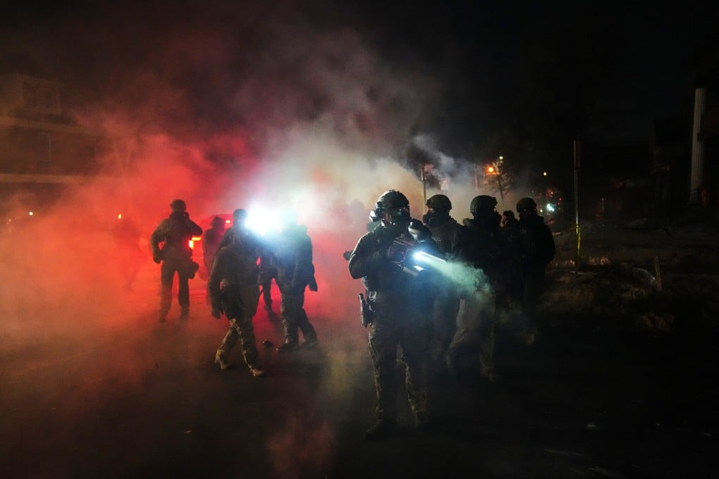 Police officers stand amid tear gas at the scene of a reported shooting in Minneapolis, Minnesota on January 14. Photo: AP
