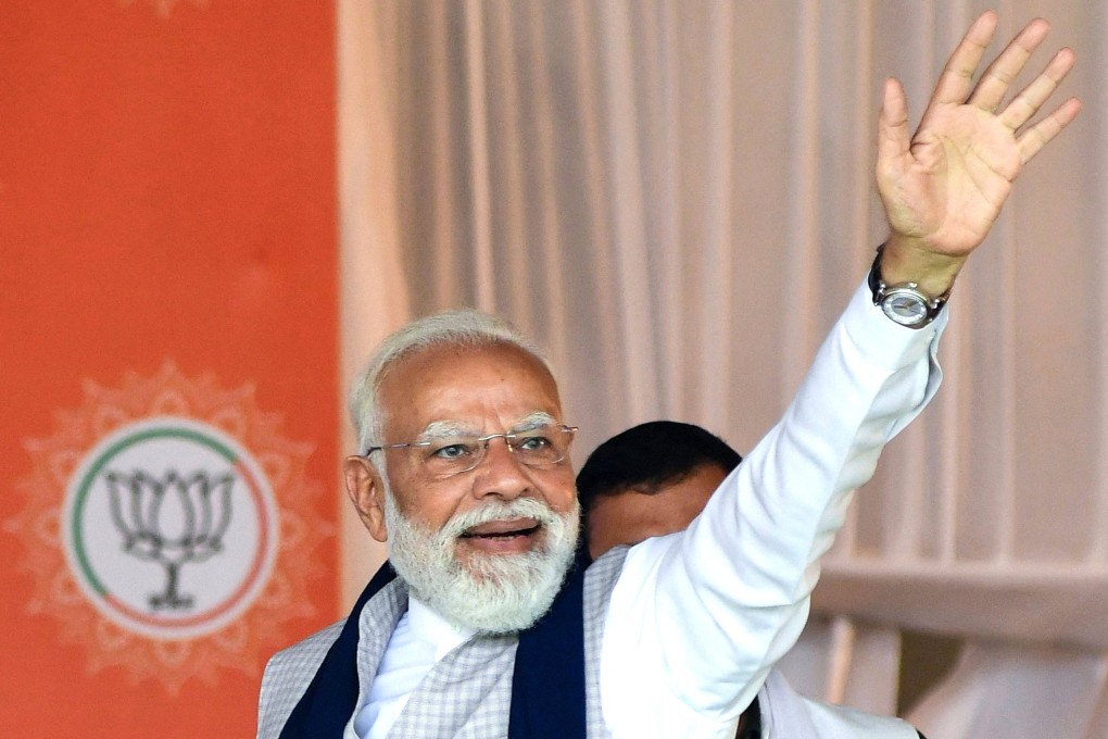 India’s Prime Minister Narendra Modi waves to his supporters during an election meeting in Barpeta on Monday ahead of the Assam state election on Thursday. Photo: AFP