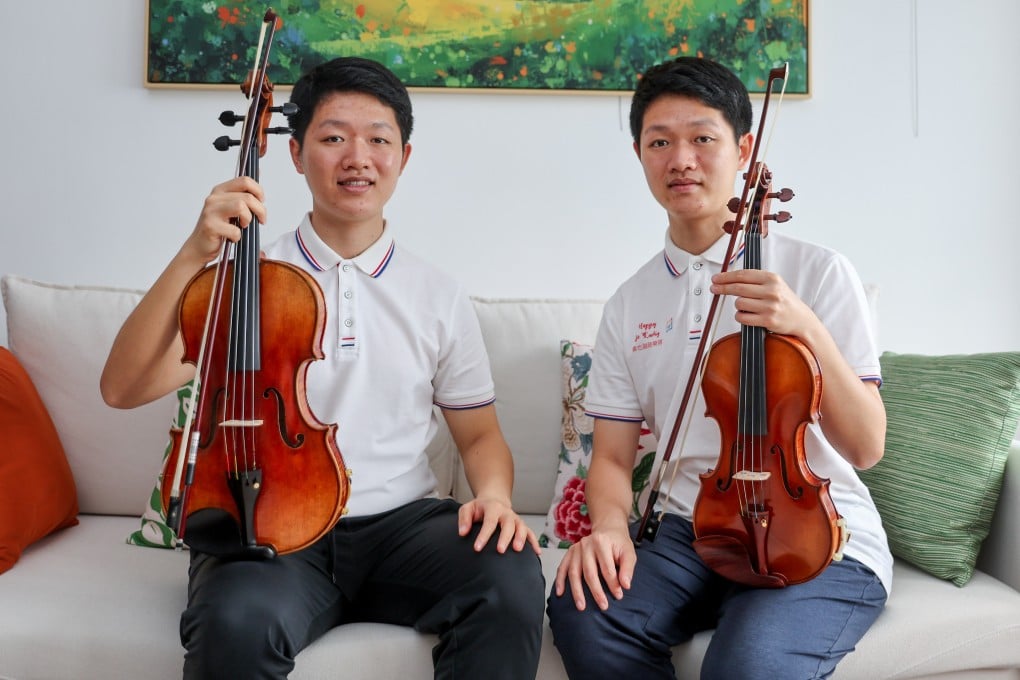Twin violinists Hugo Pang (left) and Jayden Pang are pictured with their violins in Tsim Sha Tsui, Hong Kong. The twins, now in their mid-twenties, were diagnosed with autism as toddlers. Since then, music has helped stabilise their emotions and improve their communication. Photo: Edmond So