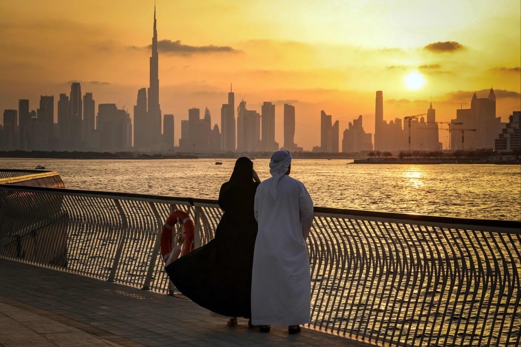 A couple stands looking at the Dubai skyline, with a view of the Burj Khalifa, the worlds tallest building, seen from Creek Harbour on April 3. Photo: AFP
