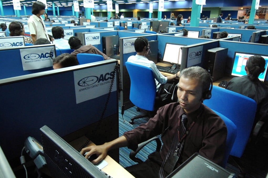 Filipino call centre personnel attend to their US clients at a business process outsourcing office in Manila. Photo: AFP