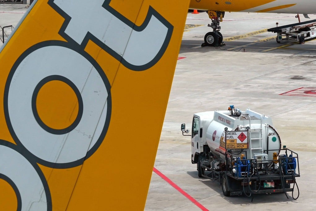 A truck carrying aviation fuel is pictured next to a Scoot plane at Singapore Changi Airport on March 13. Photo: AFP