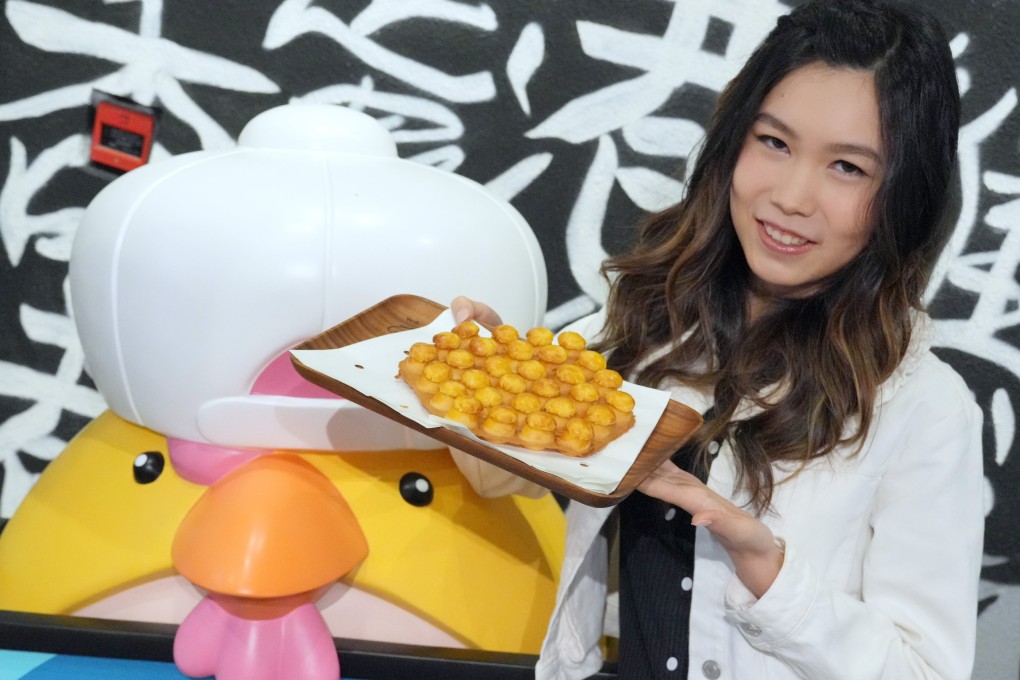 Chicken Egg Boy founder Natalie Lau holds up one of her pineapple bun egg waffle creations at her shop in Sheung Wan. She reveals her favourite Hong Kong restaurants for dim sum, fusion food, snacks and more. Photo: May Tse