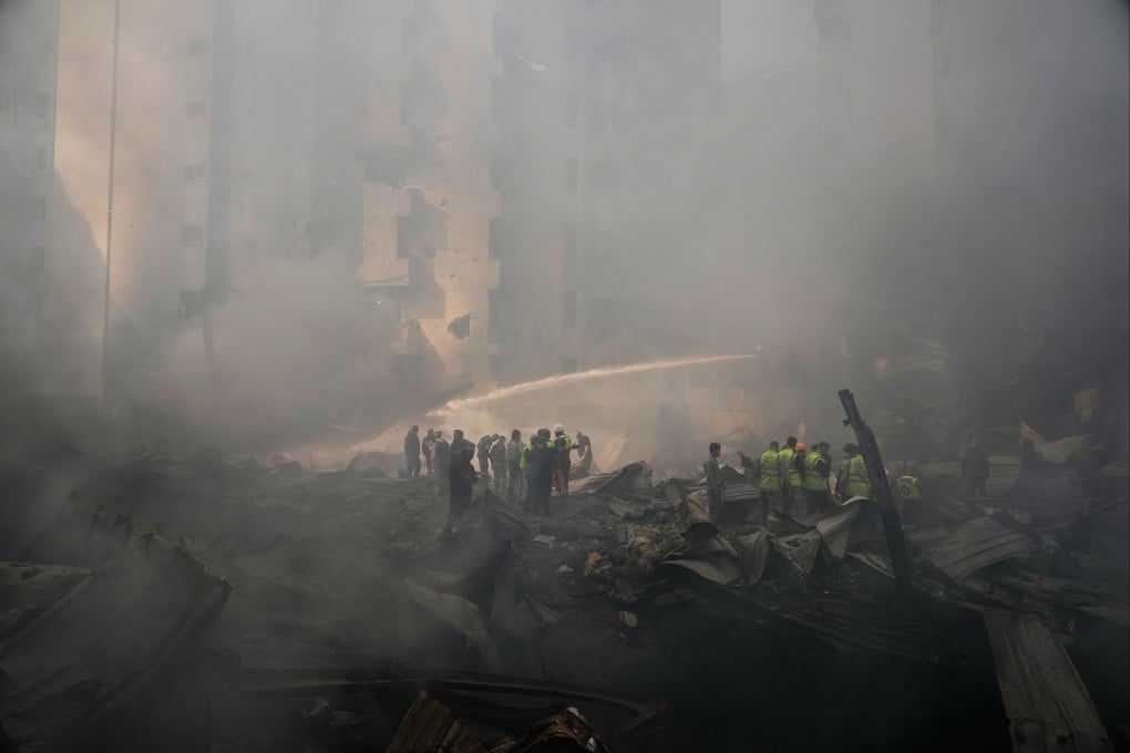 Firefighters and first responders amid smouldering debris in Beirut on Wednesday. Photo: AP