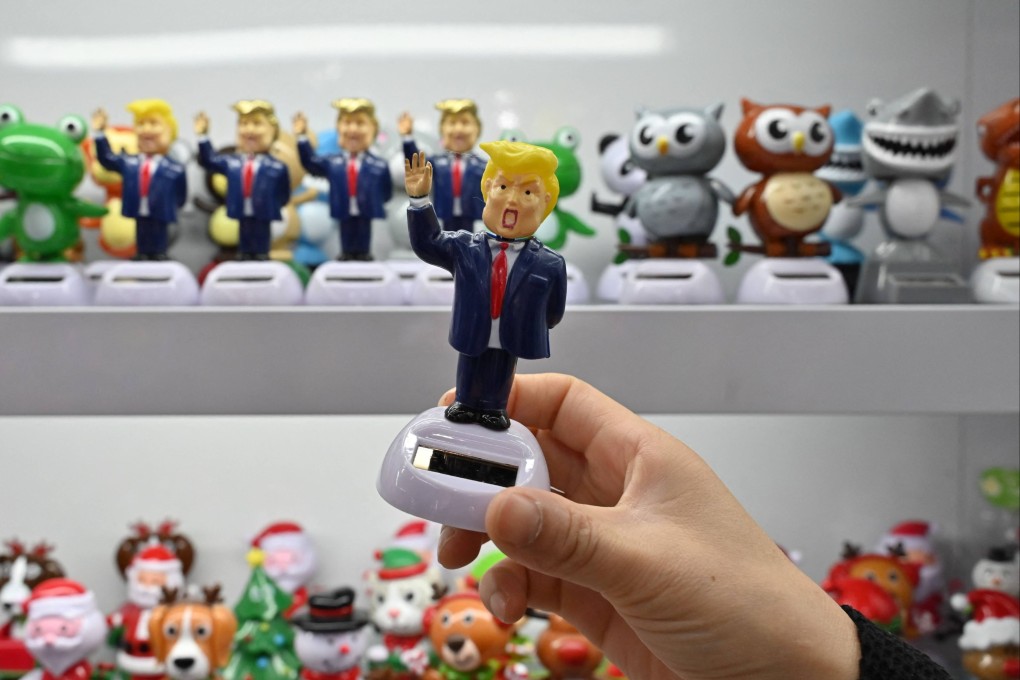 A shop owner holds a toy depicting US President Donald Trump at the Yiwu International Trade Market in Yiwu, Zhejiang province on April 10, 2025. Photo: AFP