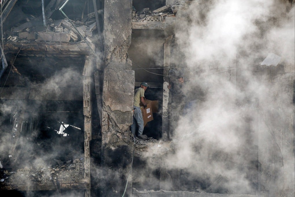 A worker tries to salvage boxes from a destroyed building in an area hit by Israeli strikes on Beirut, Lebanon, on Thursday. Photo: dpa