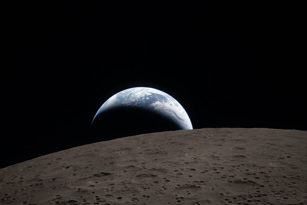 This handout, released by Nasa, shows Earth as it dips beyond the lunar horizon, also known as “Earthset”, as seen from the Orion spacecraft on April 6. Photo: AFP via Handout