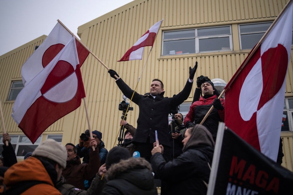 Greenland’s Prime Minister Jens-Frederik Nielsen (left) waves a flag during a protest against US President Donald Trump in Nuuk on January 17. Photo: Reuters