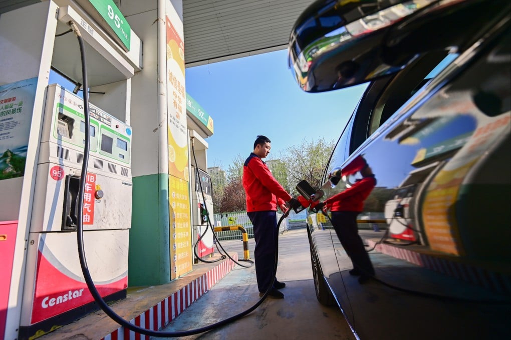 A worker fills up a car at a petrol station in eastern China’s Shandong province. Photo: Getty Images