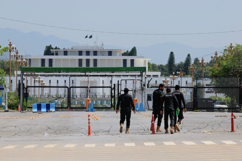 Police officers walk towards the president’s official residence in Islamabad, as Pakistan prepares to host the US and Iran for peace talks on Friday. Photo: Reuters