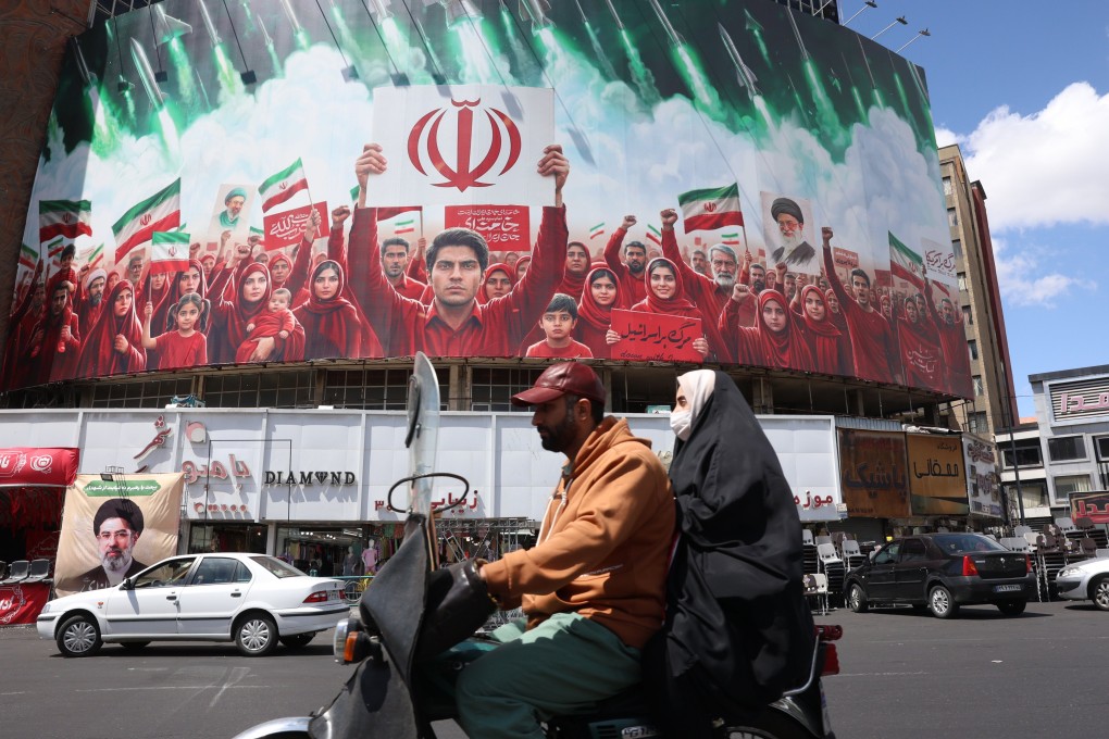 A political billboard in the colours of Iran’s national flag, seen at Tehran’s Valiasr Square on April 8. 
Formal US-Iran peace talks are set to take place in Islamabad, Pakistan, this weekend. Photo: EPA