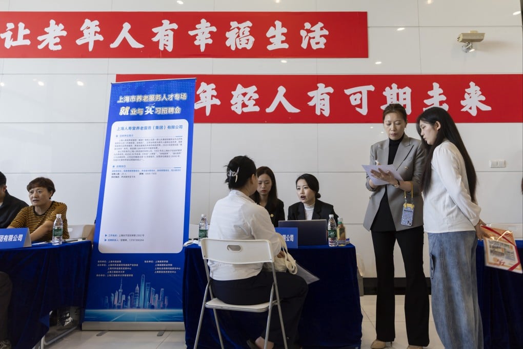 Recruiters discuss employment opportunities with job seekers at a job fair on the Songjiang campus of Shanghai University of Engineering Science on Thursday. Photo: Xinhua