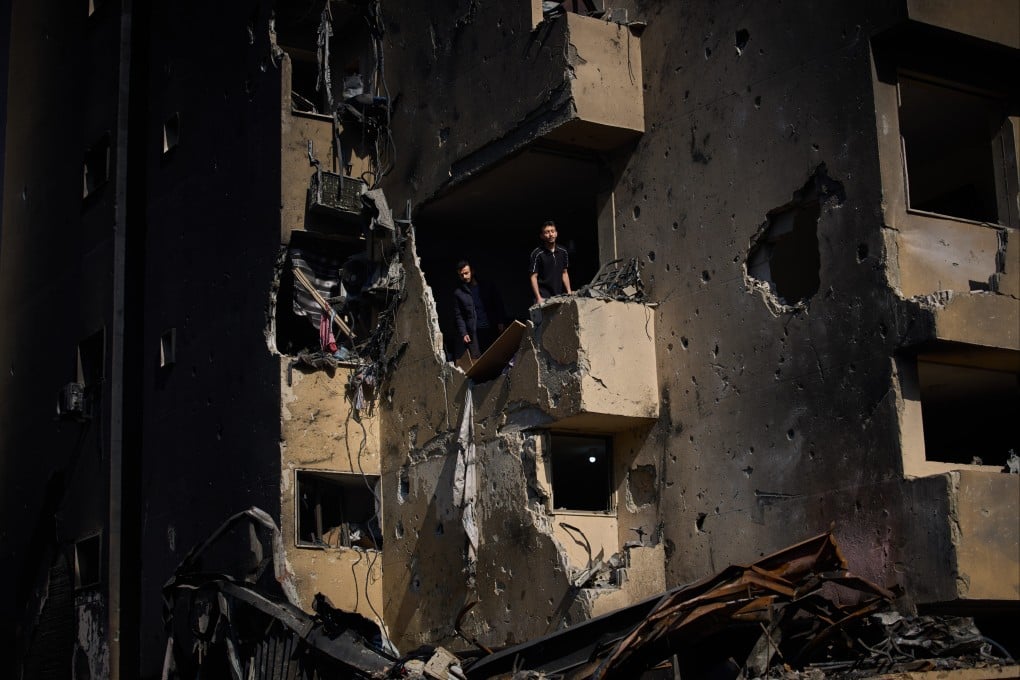 Men inspect the damage to their home destroyed in an Israeli airstrike a day earlier in Beirut, Lebanon. Photo: AP