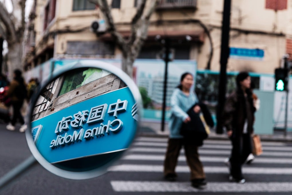 A China Mobile logo is seen in a mirror in Shanghai on March 26, 2026. Photo: EPA