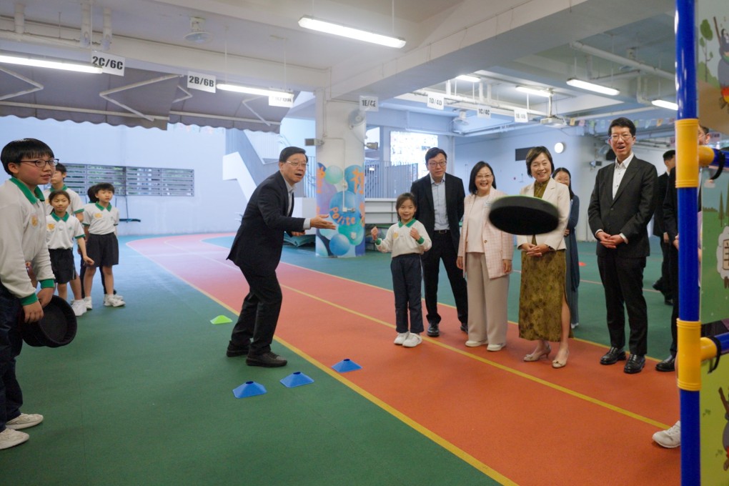 Chief Executive John Lee visits a school on March 27. He has pledged to expand the School-based After-School Care Service Scheme. Photo: Handout