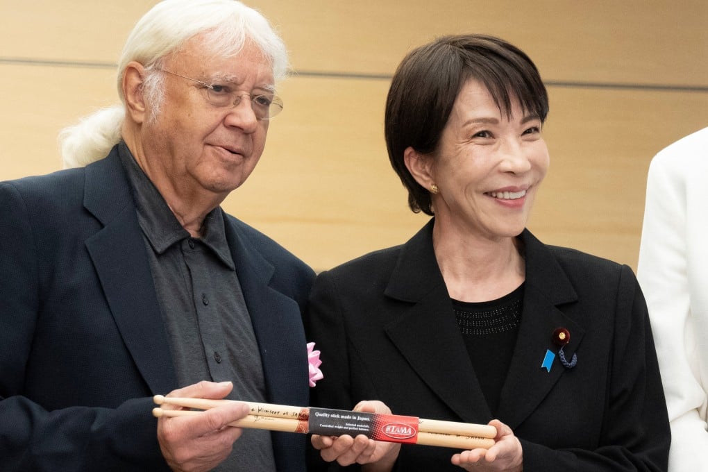 Japanese Prime Minister Sanae Takaichi gives Made-in-Japan drumsticks to Deep Purple drummer Ian Paice at the Prime Minister’s Office in Tokyo on Friday. Photo: Reuters