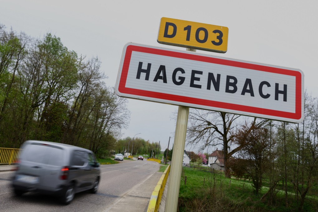 A car drives past a road sign at the entrance to Hagenbach, France, where a boy was rescued this week from his father’s van. Photo: AP