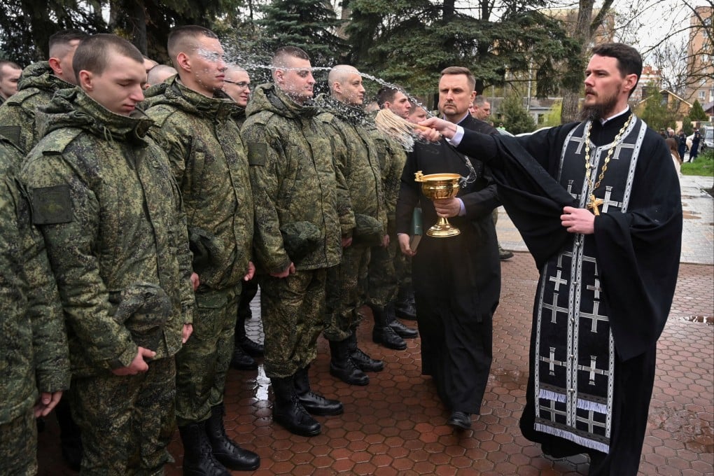 An Orthodox priest blesses Russian conscripts during a ceremony in Bataysk, in the Rostov region of Russia on Friday. Photo: Reuters