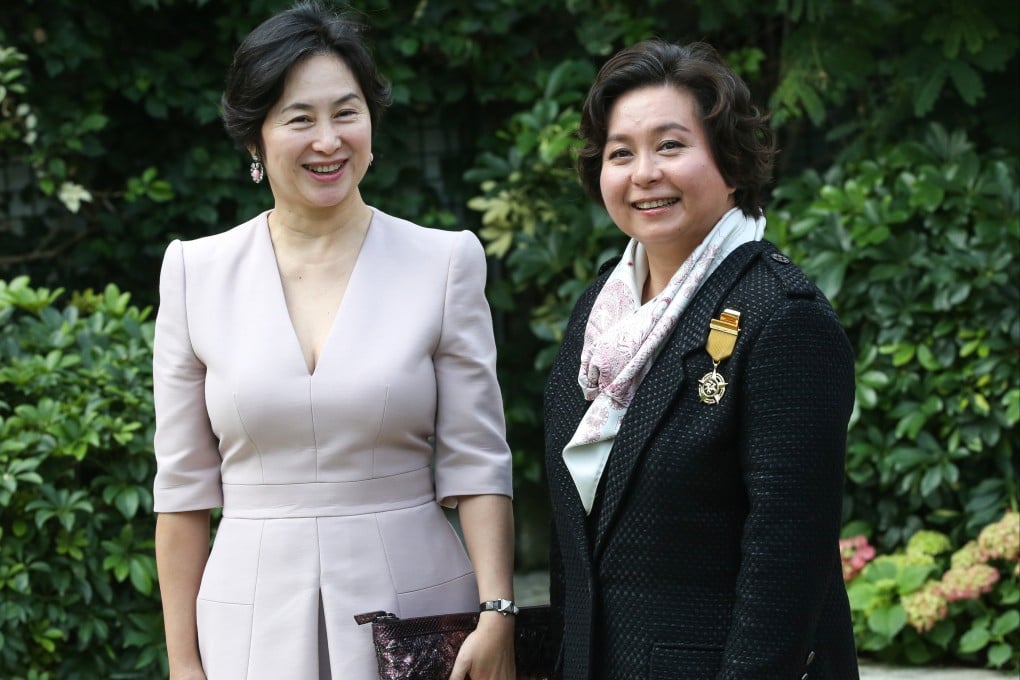 Maisy Ho (right) and her sister, Pansy Ho, attend a ceremony at Government House in 2016, where Maisy received the Bronze Bauhinia Star. Photo: Edward Wong